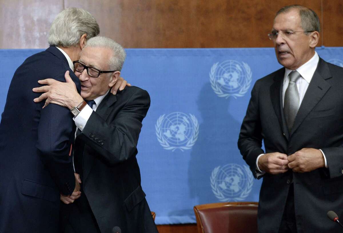 U.S. Secretary of State John Kerry (left) embraces United Nations-Arab League special envoy for Syria Lakhdar Brahimi after high-stakes talks Friday on Syria's chemical weapons.