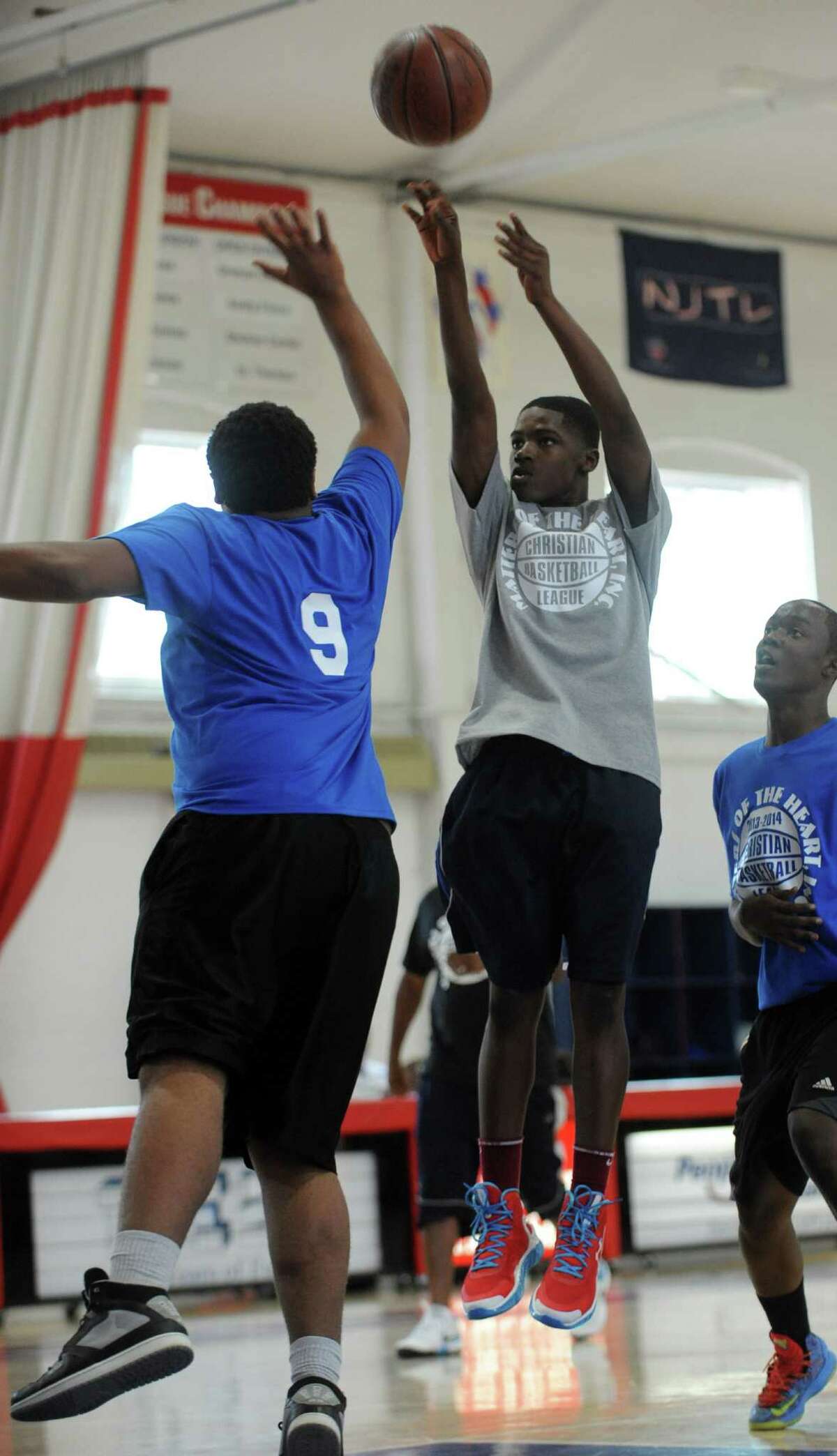 Ty Hubbard, 14, of Hamden, shoots the ball during the first game of the Christian Basketball League Saturday Sept. 14, 2013 at the Cardinal Shehan Center in Bridgeport, Conn.