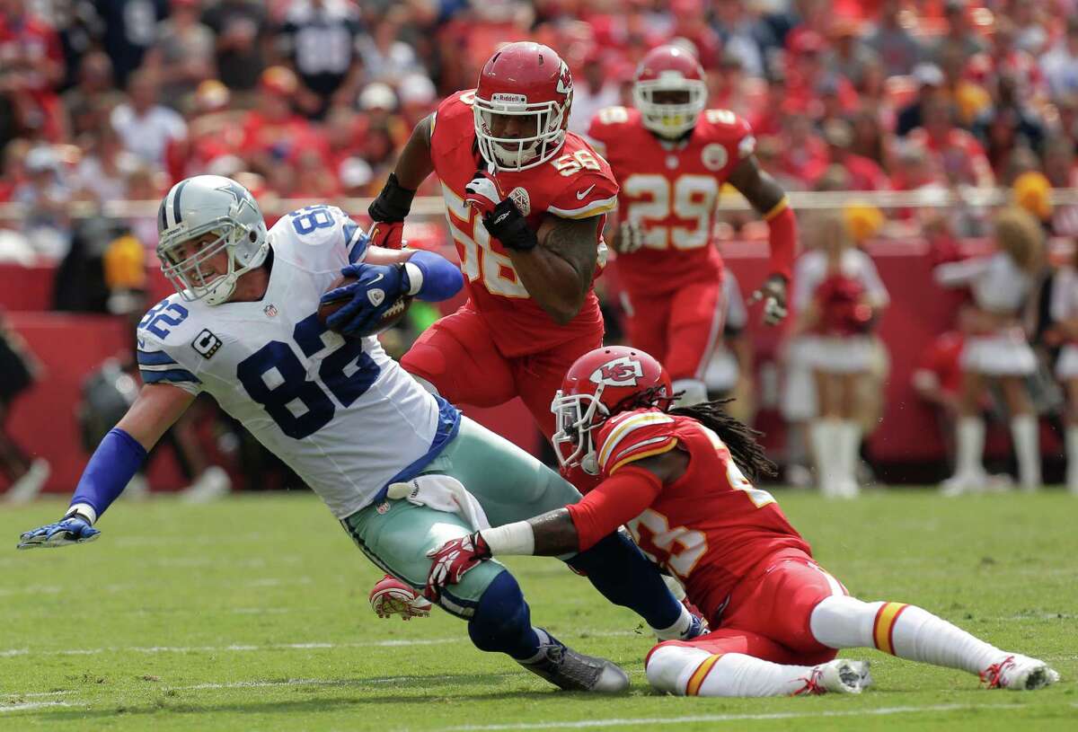Dallas Cowboys tight end Jason Witten (82) is tackled after a catch by Kansas City Chiefs free safety Kendrick Lewis (23) during the first half of an NFL football game at Arrowhead Stadium in Kansas City, Mo., Sunday, Sept. 15, 2013. (AP Photo/Charlie Riedel)