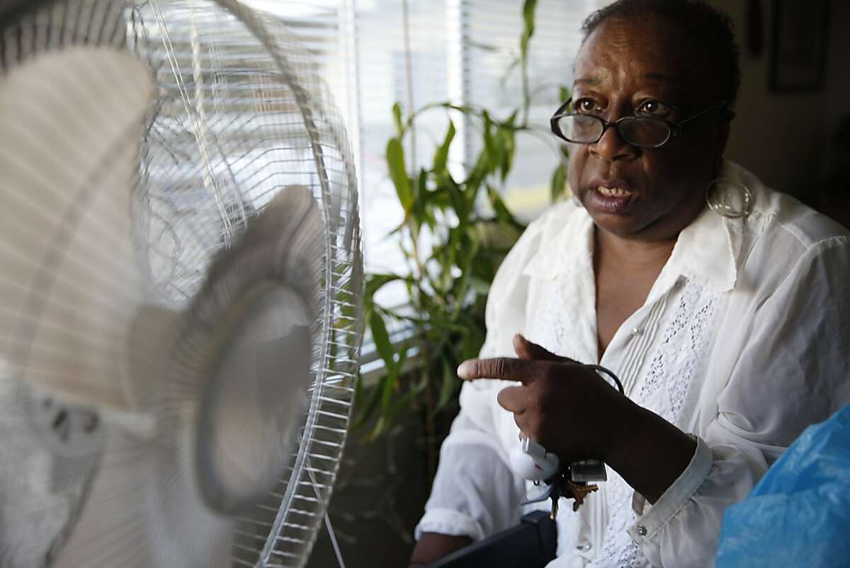 Margaret Gordon (l to r) , founding member and co-director of the West Oakland Environmental Indicators Project, points to soot and grime built up on her fan blade and fan cover at her home on Monday, September 9, 2013 in Oakland, Calif.