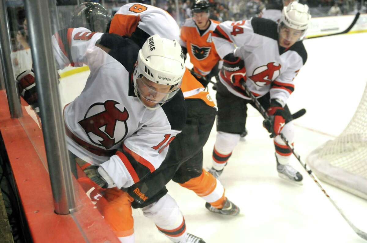 Albany Devils? Harri Pesonen, left, fights for the puck with Rob Bordson of the Adirondack Phantoms, #8, Sunday evening April 21, 2013, at the Times Union Center in Albany, N.Y. (Will Waldron/Times Union)