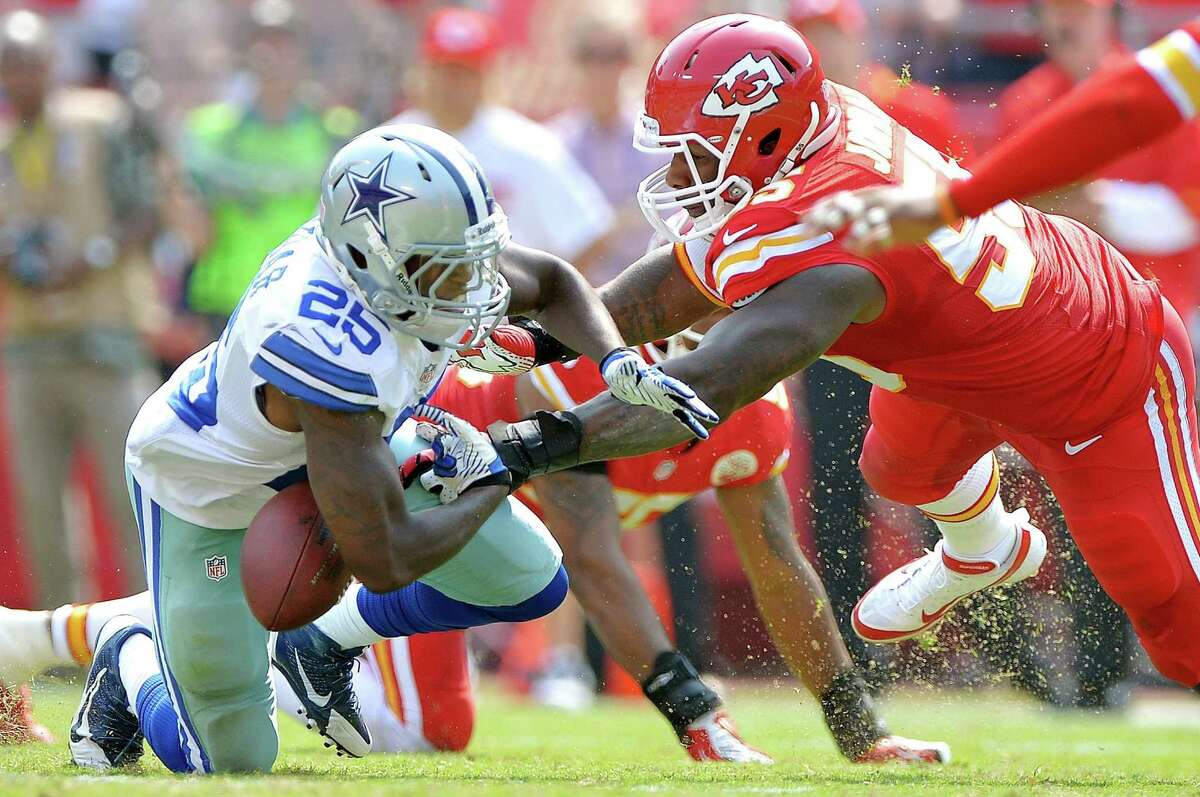 Kansas City Chiefs inside linebacker Akeem Jordan (55) forces Dallas Cowboys running back Lance Dunbar (25) to fumble, allowing Eric Berry to recover the ball in the third quarter at Arrowhead Stadium in Kansas City, Missouri, on Sunday, September 15, 2013. The Chiefs defeated the Cowboys, 17-16. (John Sleezer/Kansas City Star/MCT)