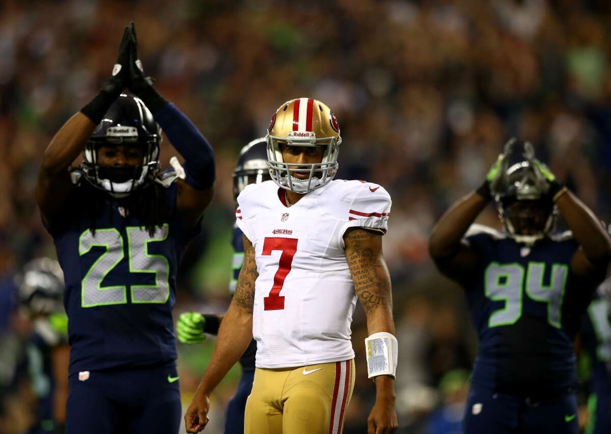 Seahawks cornerback Richard Sherman (left) said he understood the statement 49ers quarterback Colin Kaepernick (center) made by not standing for the national anthem this preseason, but thinks perhaps Kaepernick could have picked a better platform for his message.