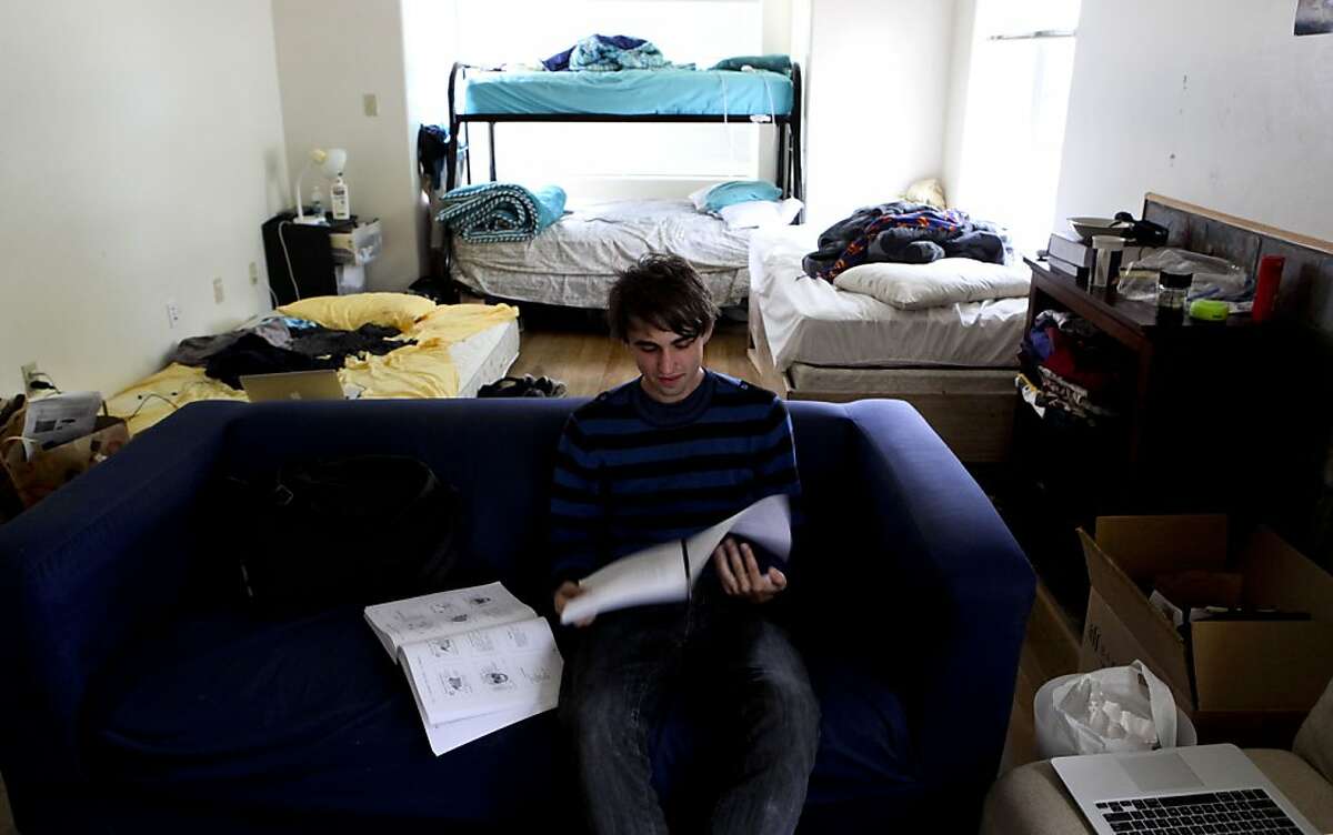 UC Berkeley student Igor Akimenko, on Wednesday Sept. 11, 2013, inside the converted living room where he shares sleeping arrangements with three other students in Berkeley, Calif. The City of Berkeley is considering a crackdown on so called "mini-dorms", houses with many students living inside. Housing is so expensive students are left with few options when finding a place to live while going to school.