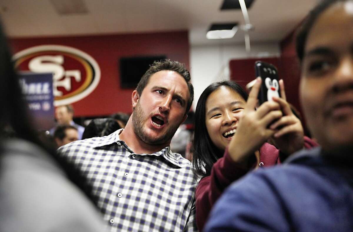 49ers left tackle Joe Staley (l to r) poses for a photo with Thurgood Marshall sophomore Hanh Nguyen, 15, before they play "Financial Football" with other students along with with 49er Colt McCoy(not shown) , California State Controller John Chiang (not shown) and California State Board of Equalization member Betty Yee (not shown) in the 49ers locker room at Candlestick Park on Monday, September 16, 2013 in San Francisco, Calif.