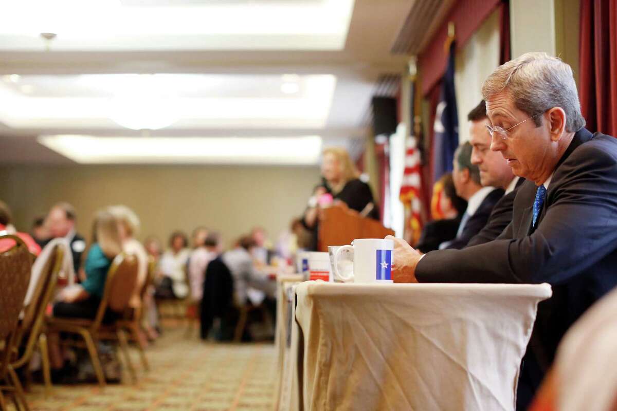 Candidate Jerry Patterson, right, takes notes during a debate between the four candidates for lieutenant governor, Monday, September 16, 2013 at the Republican's women's forum at the Doubletree hotel in Houston, Texas. 