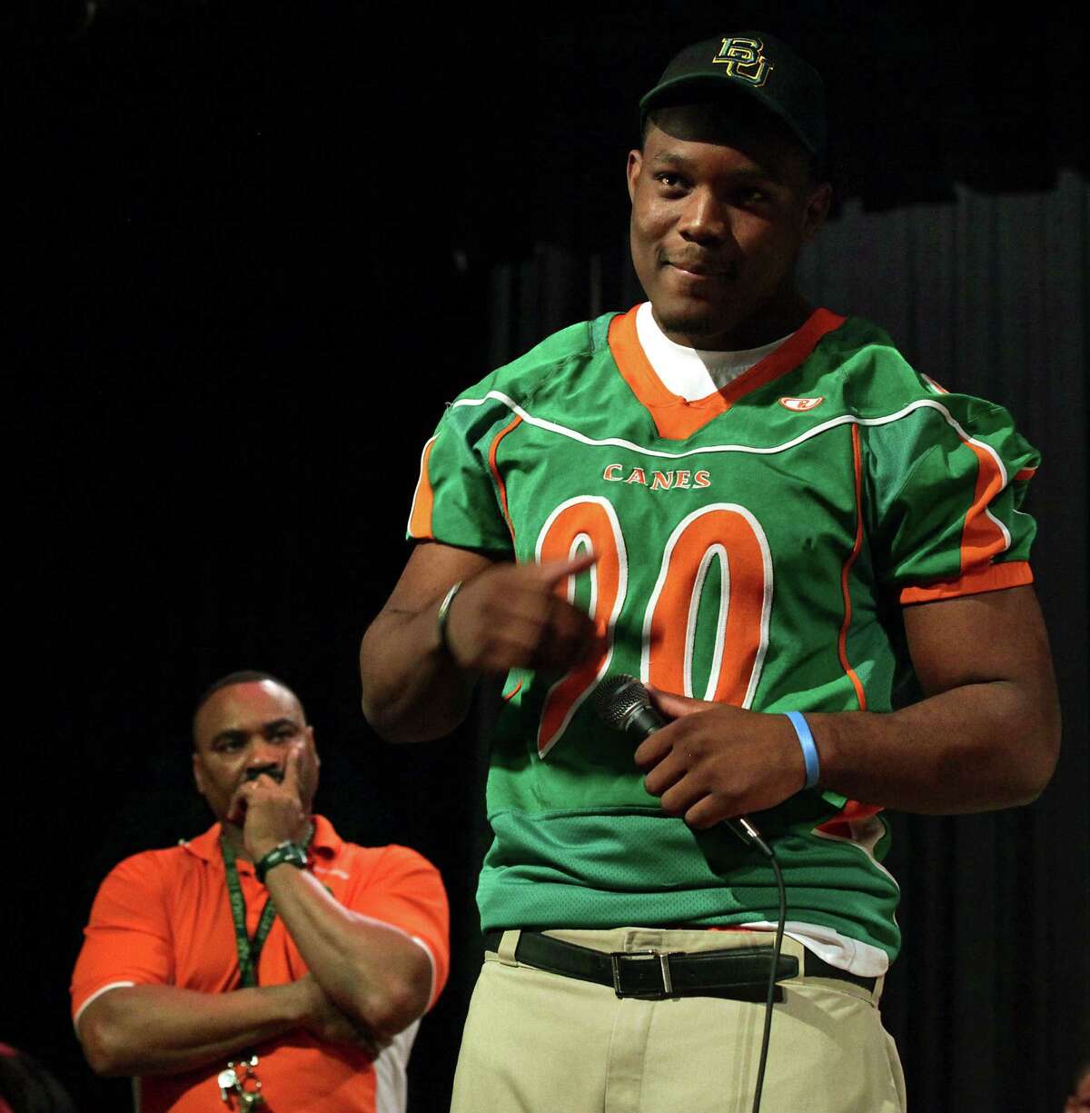 Javonte Magee speaks as Sam Houston Coach Gary Green listens in February 2012 just after Magee and several others signed with Baylor University.