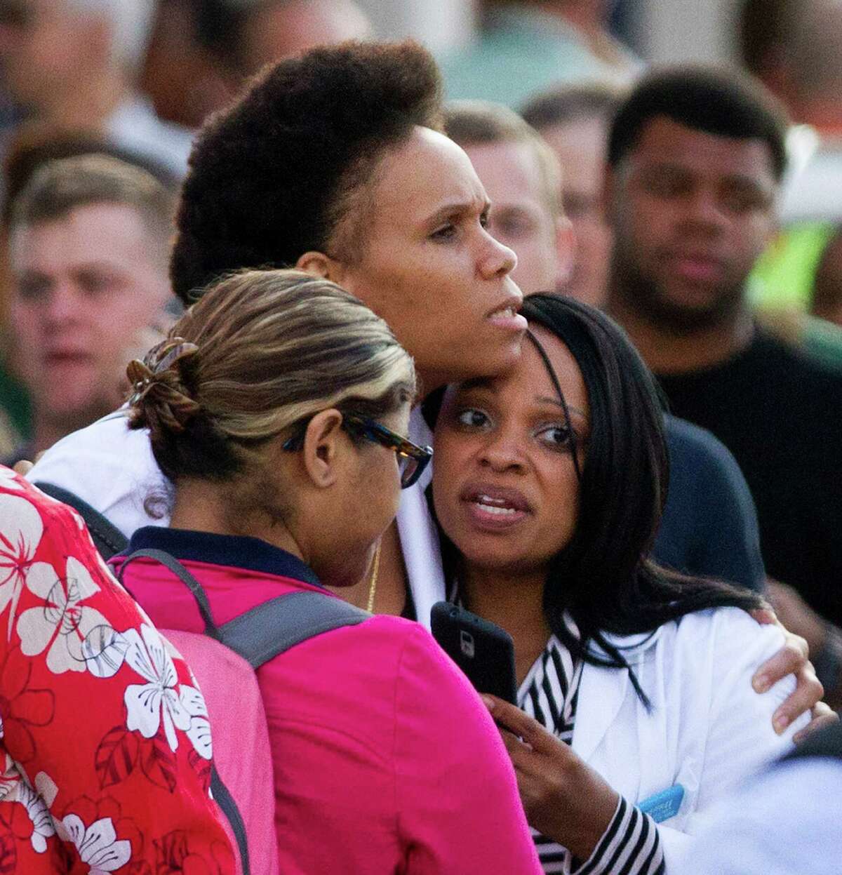 Family and friends wait at a baseball stadium parking lot to be reunited with workers who survived the shooting rampage at the Washington Navy Yard.