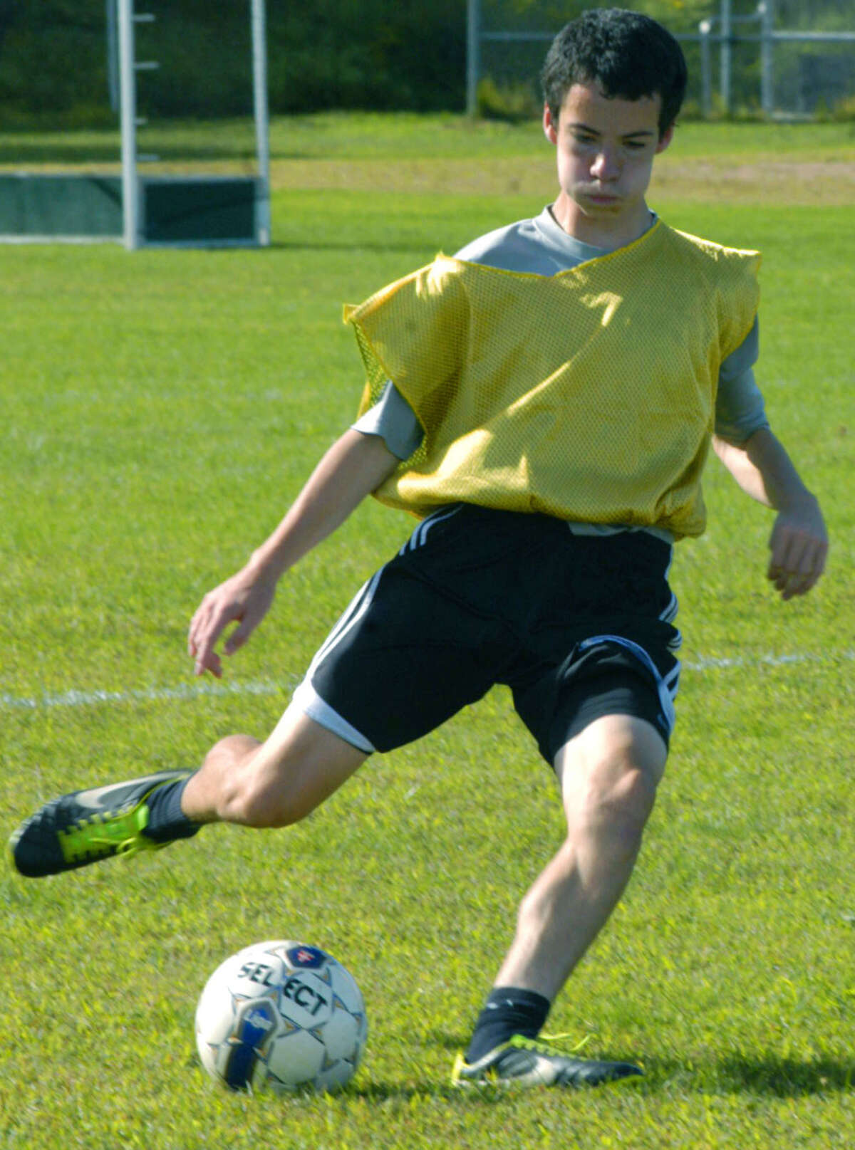 Jarod Riedl of the Green Wave leans into a crossing pass during pre-season practice for New Milford High School boys' soccer. September 2013