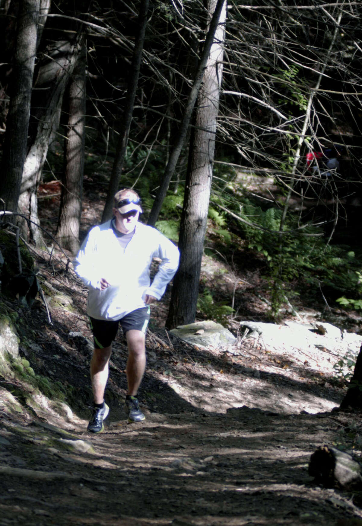 After spending hours prepping a Steep Rock Reservation trail for his runners, New Milford High School girls' cross country coach Giles Vaughan gives it a test run before sending his Green Wave athletes on a rigorous workout in Washington. September 2013