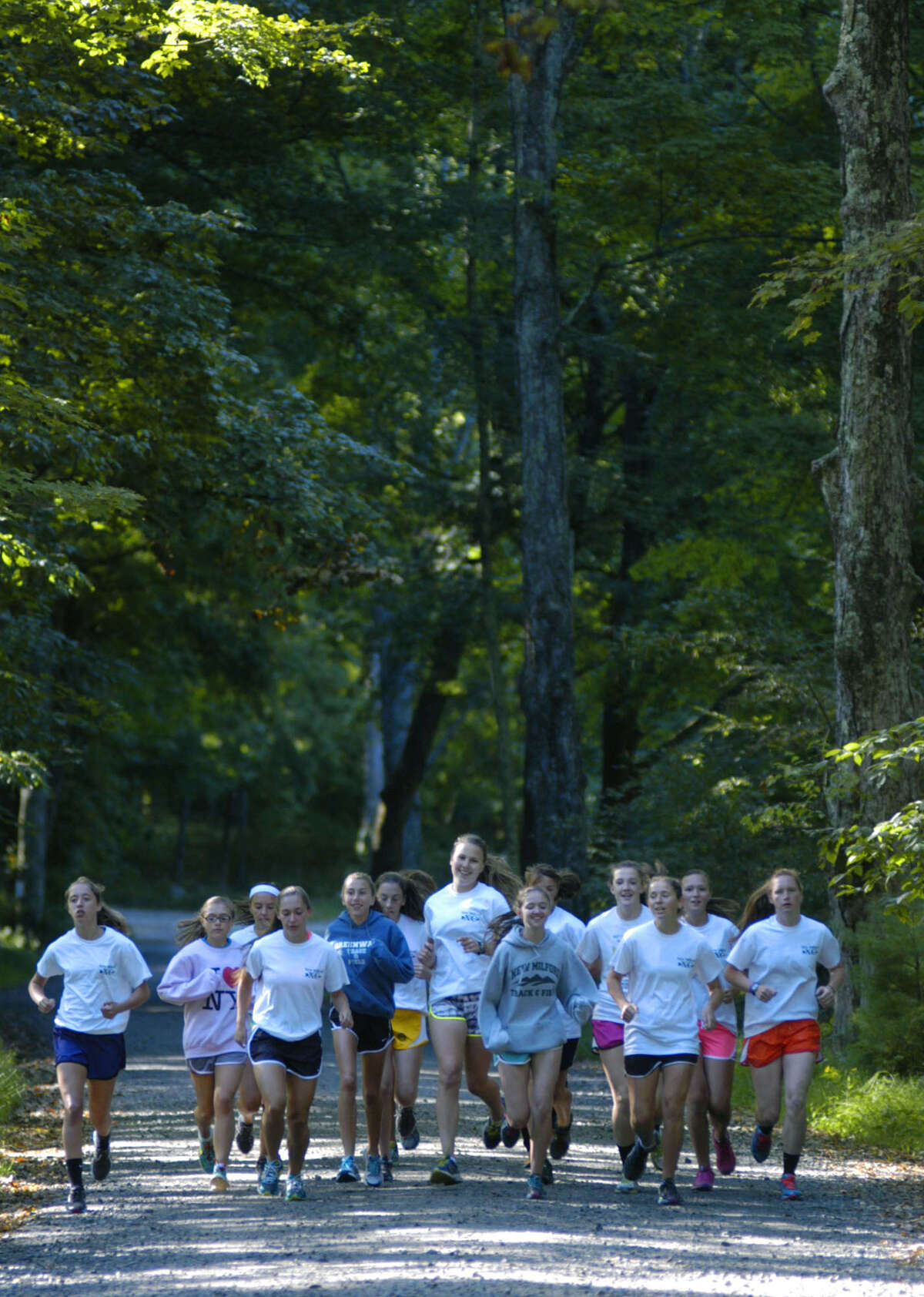 The Green Wave runners enjoy a light warmup run at Steep Rock Reservation in Washington before engaging in a tough workout for the New Milford High School girls' cross country season. September 2013