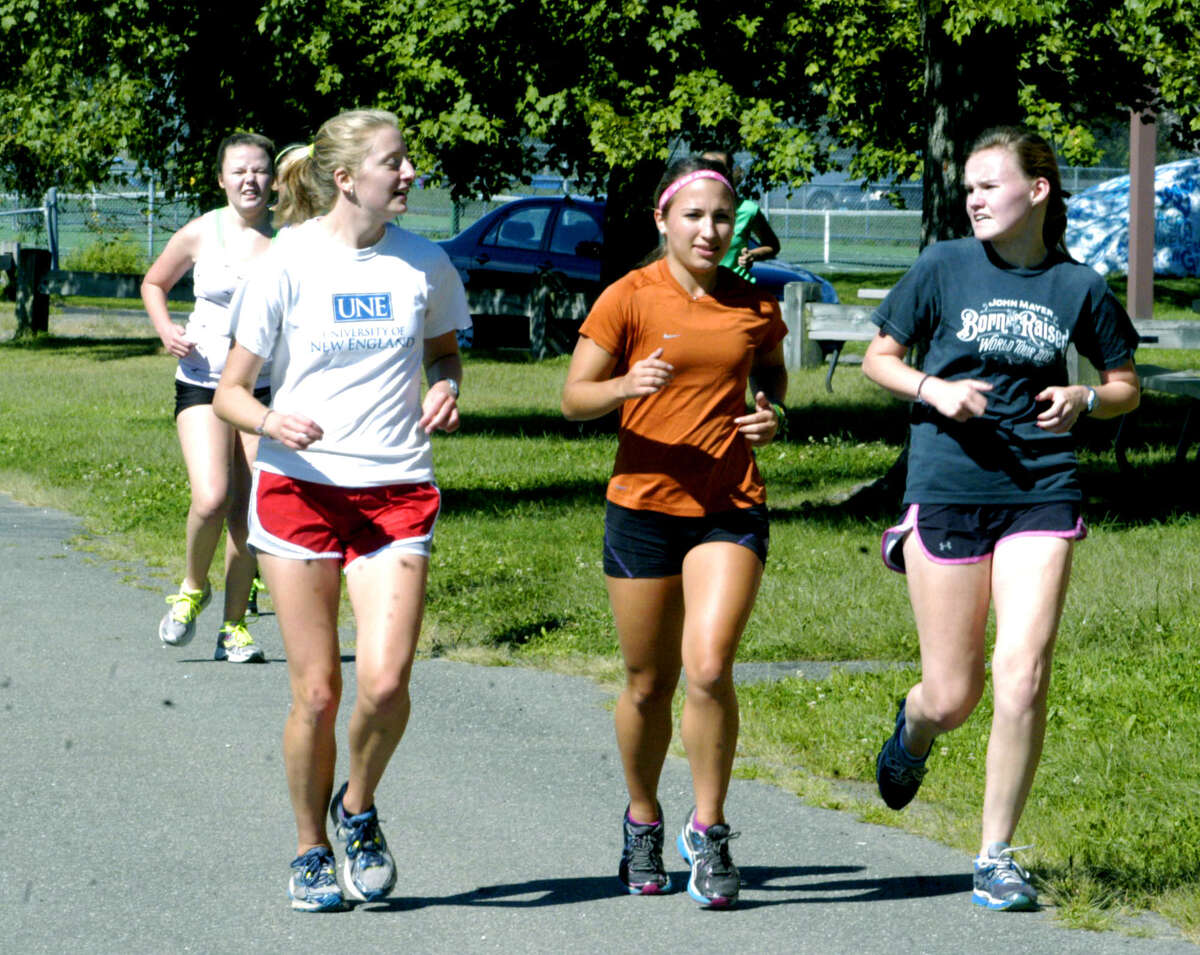 Socializing a bit as they enjoy a warmup run before a pre-season practice are, from left to right, Clara Wolfe, Kelsey Hall and Sarah Williams of Sherpaug Valley High School girls' cross country. September 2013