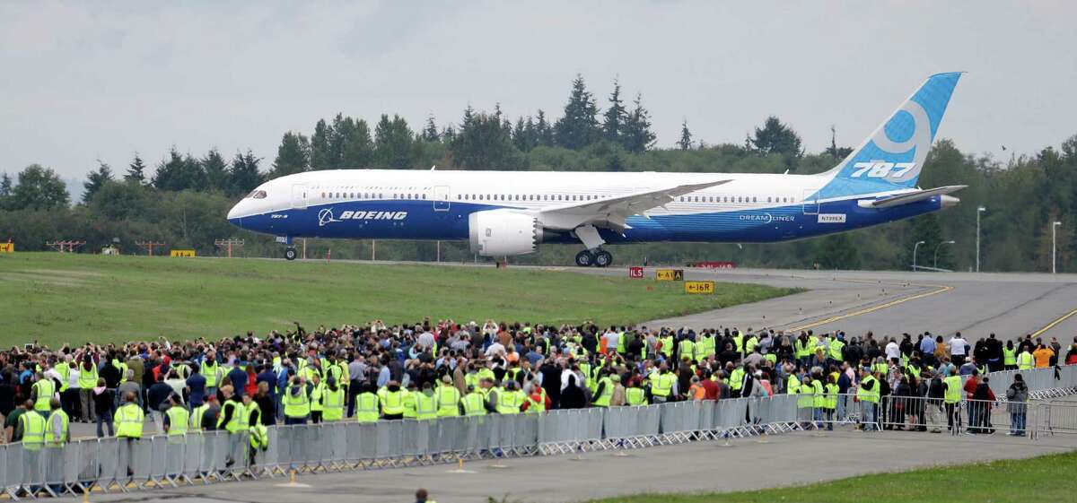 A Boeing 787-9 rolls past employees and guests before taking off Tuesday, Sept. 17, 2013, at Paine Field in Everett, Wash. The 787-9 is 20 feet longer and can seat 40 more passengers than the original 787-8, which carries between 210 and 250 passengers. The new version of the Dreamliner also can carry more cargo and fly farther.