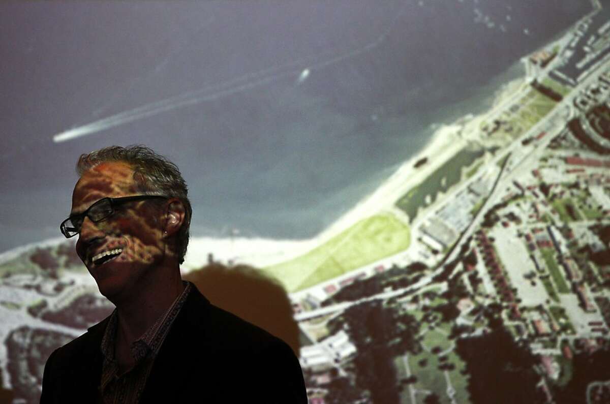 Marc L'Italien, Design Principal, EHDD, laughs as he chats with people in front of a projection of Crissy Field Center before an architectural forum featuring three finalists presenting on the new Presidio cultural institution plans September 17, 2013 at the AIA San Francisco / Center for Architecture + Design in downtown San Francisco, Calif. The presentations were part of the Architecture and the City Festival, an event being held through the end of the week featuring discussions and lectures on architecture, design and urban planning.