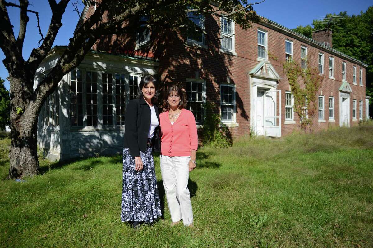 Donna DeLuca, left, and Dorrie Carolan, founders and directors of the Newtown Parent Connection, plan to renovate this building on the Fairfield Hills campus in Newtown, Conn. to expand their organization that helps parents coping with adolescent substance abuse and addiction issues.