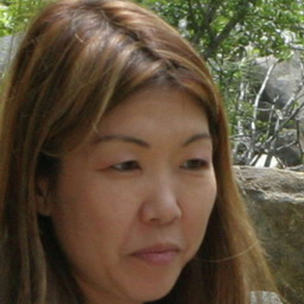 Chie Kawabata, pictured in a family photo. Kawabata is believed to have kidnapped her son Maximus and taken the boy to Japan.