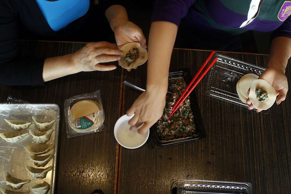 Lily Fang, left, and Kathy Fang, right, make dumplings at their restaurant House of Nanking in Chinatown in San Francisco, Calif. on August 15, 2013.