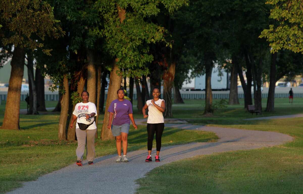 Sherean Goodie, left, Tanya Wilson, and LaTreice Garrett, right, walk in Hutcheson Park near Lockwood and 610, Wednesday, Oct. 17, 2012, in Houston. Parks By You is working to promote the bond measure on the Nov. 6 ballot that would include connecting the Hutcheson Park to the Mickey Leland Memorial Park, 3701 Cavalcade Street, by extending Hunting Bayou Hike and Bike Trail.