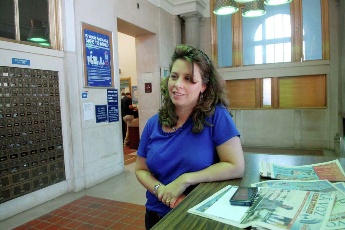 Christine Limone a Milford resident who grew up in Stamford came to mail a letter at the historic downtown post office which is closing the end of the day on Friday September 20, 2013 after 97 years on Atlantic Street in Stamford, Conn.