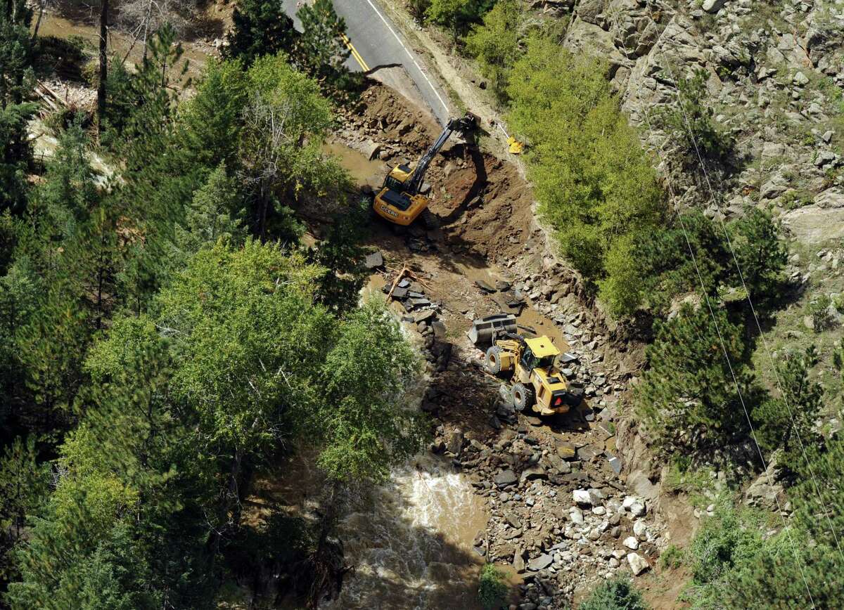 Heavy equipment is seen on a road outside Boulder, Colo. Flooding has damaged more than 200 miles of state highways.