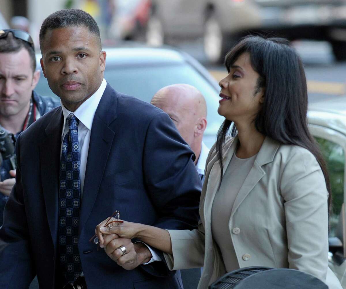 FILE - In this Wednesday, Aug. 14, 2013, file photo, former Illinois Rep. Jesse Jackson Jr. and his wife, Sandra, arrive at federal court in Washington, to learn their fates when a federal judge sentences the one-time power couple for misusing $750,000 in campaign money on everything from a gold-plated Rolex watch and mink capes to vacations and mounted elk heads. Jesse Jackson Jr.'s posessions _ including fur capes and Michael Jackson memorabilia _ go on the auction block Tuesday, Sept. 17, 2013, in an attempt to generate cash to pay his $750,000 fine for fundraising violations. (AP Photo/Susan Walsh, File)