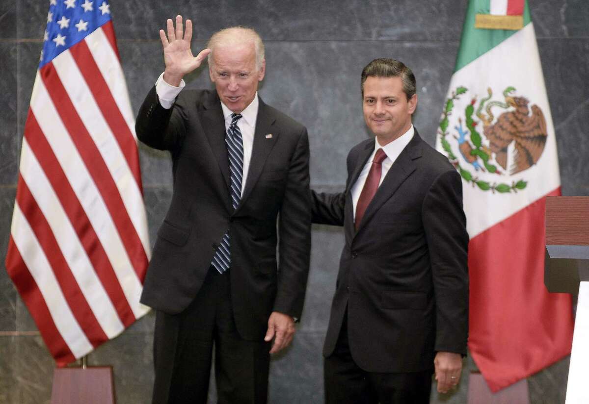 Vice President Joe Biden waves next to Mexican President Enrique Pena Nieto in Mexico City. In addition to economic partnership, the two discussed increasing student exchanges and joint research.