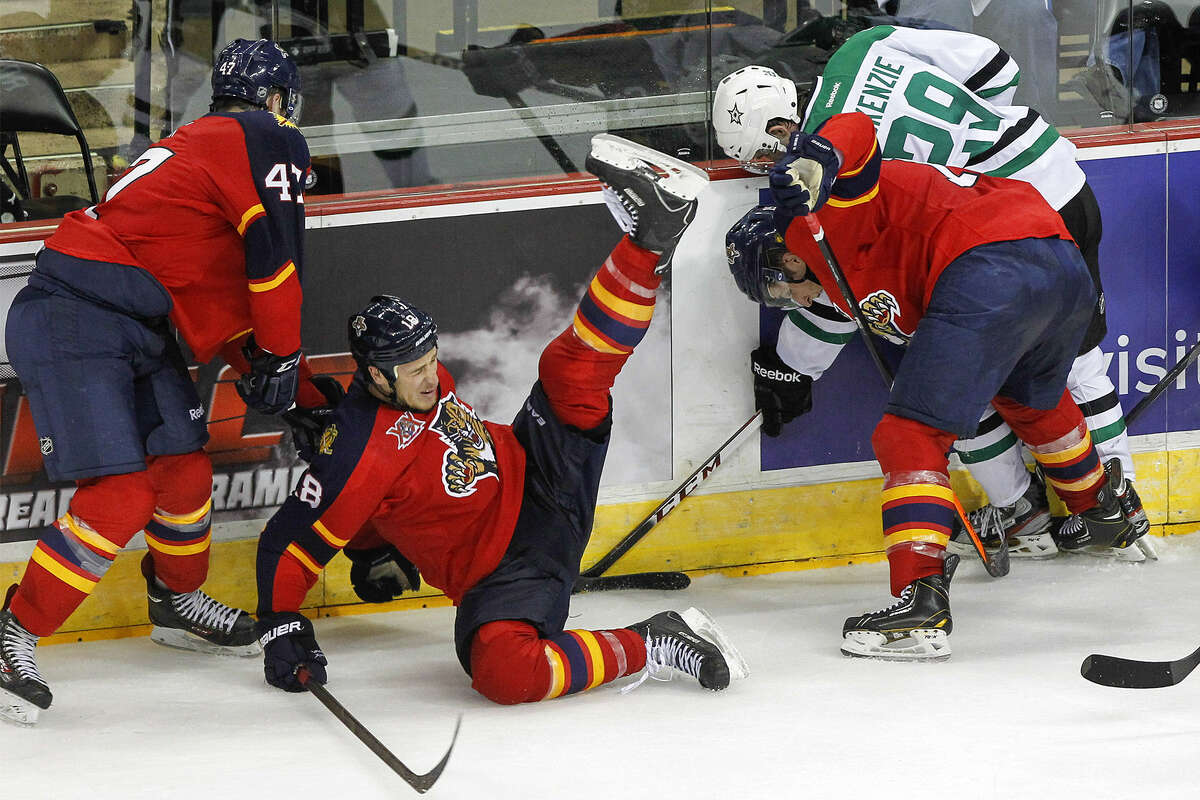 Florida's Shawn Matthias (second from left) falls as Dallas' Curtis McKenzie (far right) fights for the puck.