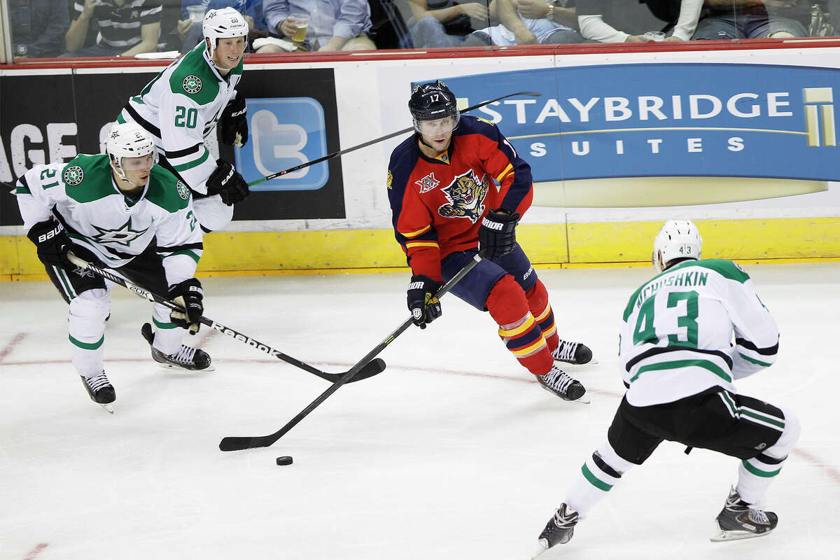 Jesse Winchester (center) of the Florida Panthers looks to pass the puck between Antoine Roussel (from left), Cody Eakin and Valeri Nichushkin of the Dallas Stars during the second period of their NHL exhibition game at the AT&T Center on Friday, Sept. 20, 2013. The Panthers are the NHL parent club of the AHL'x San Antonio Rampage. MARVIN PFEIFFER/ mpfeiffer@express-news.net