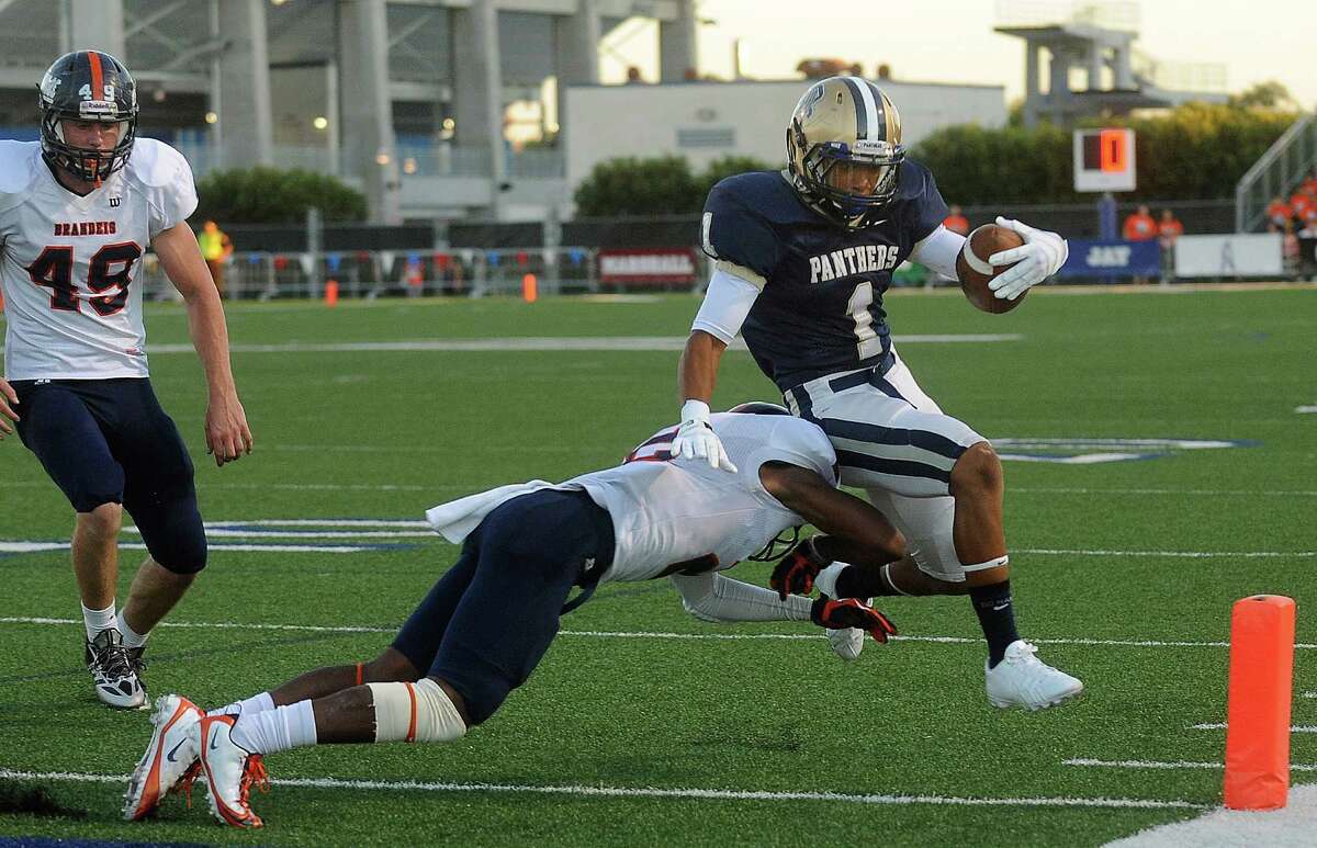 O'Connor running back Jeilyn Williams scores a first half touchdown as Kadarius Lee of Brandeis attempts to stop him during high school football action at Farris Stadium on Saturday, Sept. 21 2013.