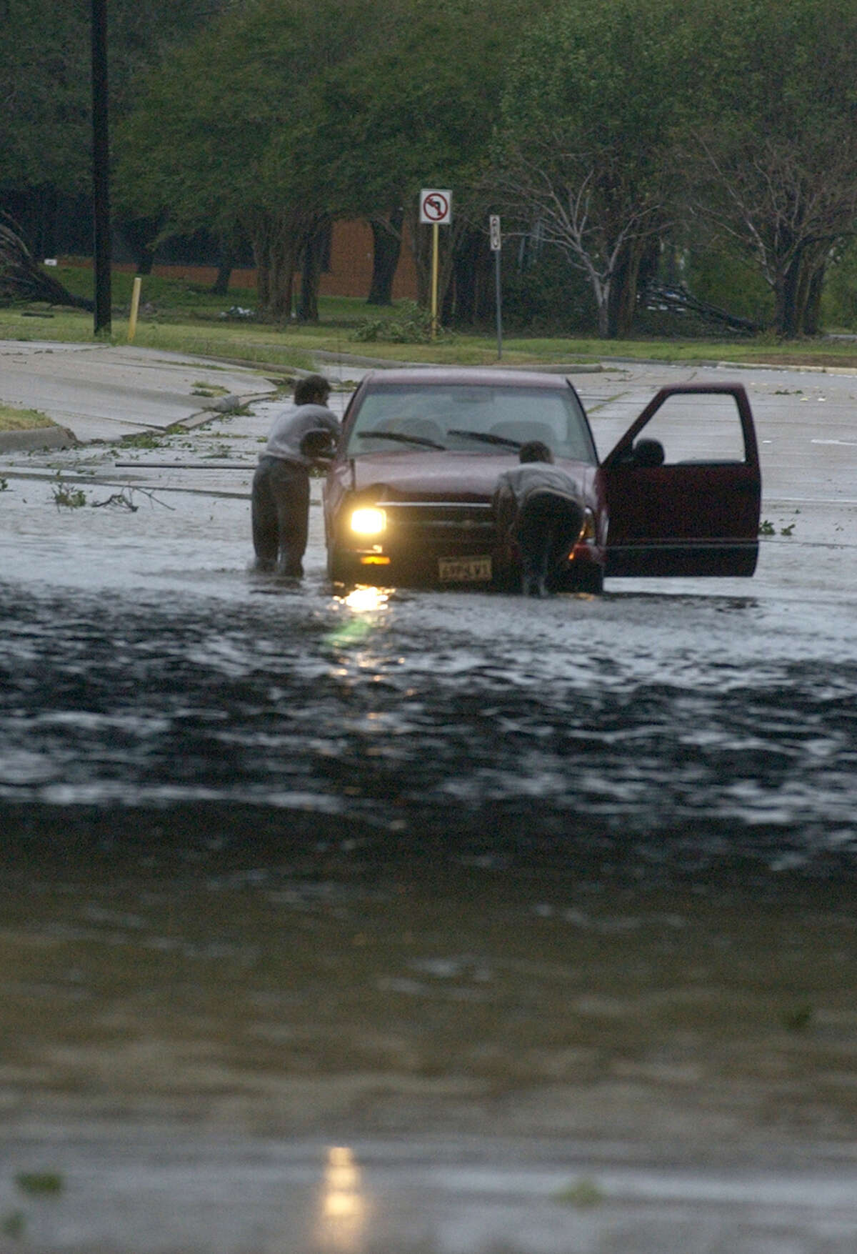 Motorists push their car out of high water under Interstate 10 in Beaumont Saturday September 24, 2005 after Hurricane Rita passed through the area overnight. Many roads were underwater and underpasses where underwater following the storm. Photo/Jennifer Reynolds - The Beaumont Enterprise