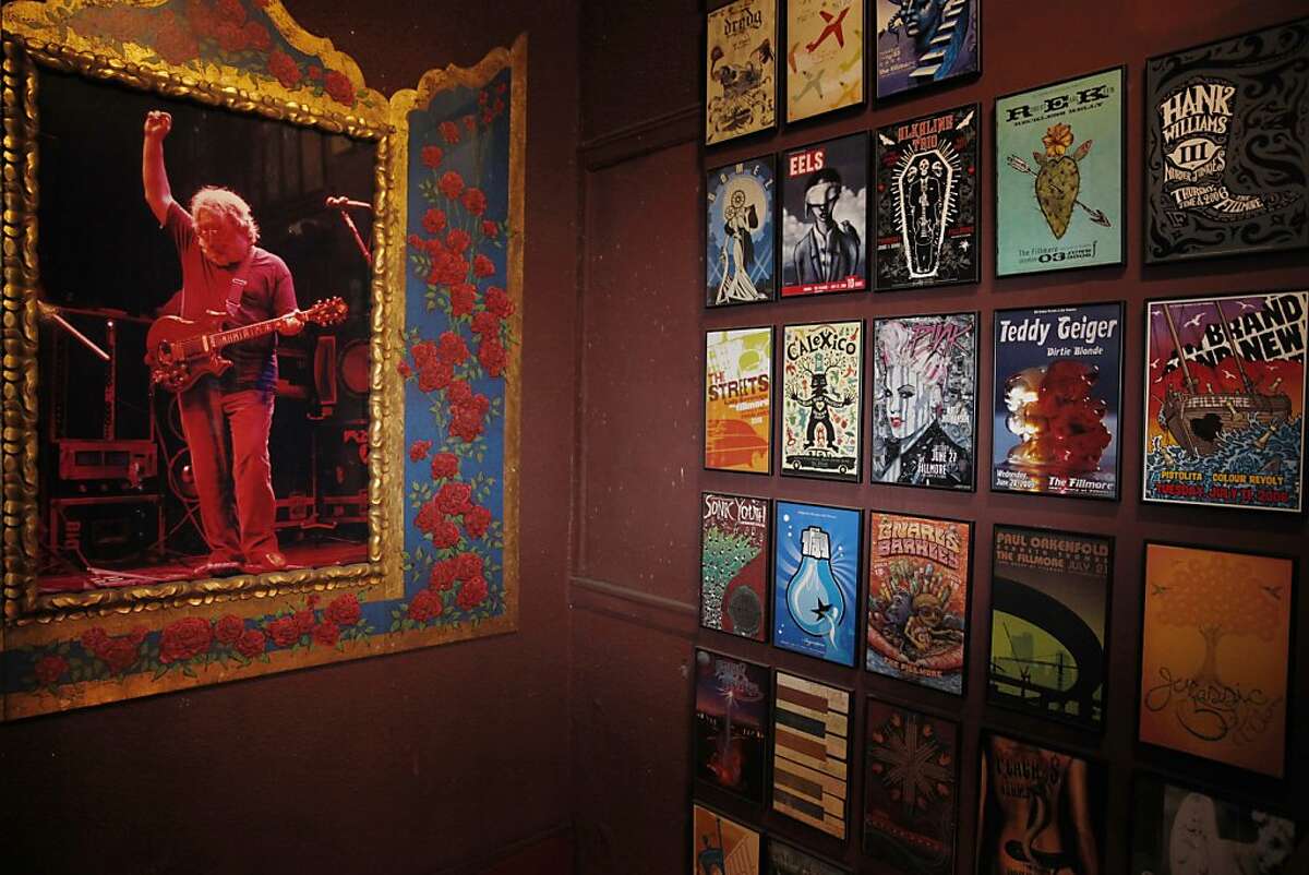 Posters from the Fillmore hang on a wall next to a staircase next to a large portrait of Jerry Garcia at the Fillmore after it reopened on Thursday, September 12, 2013 in San Francisco, Calif.