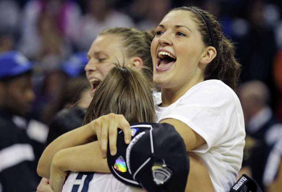 Connecticut forward Breanna Stewart smiles as she embraces teammate Stefanie Dolson after beating Kentucky in the women's NCAA regional final basketball game in Bridgeport, Conn., Monday, April 1, 2013. Connecticut won 83-53 and advances to the Final Four. (AP Photo/Charles Krupa)