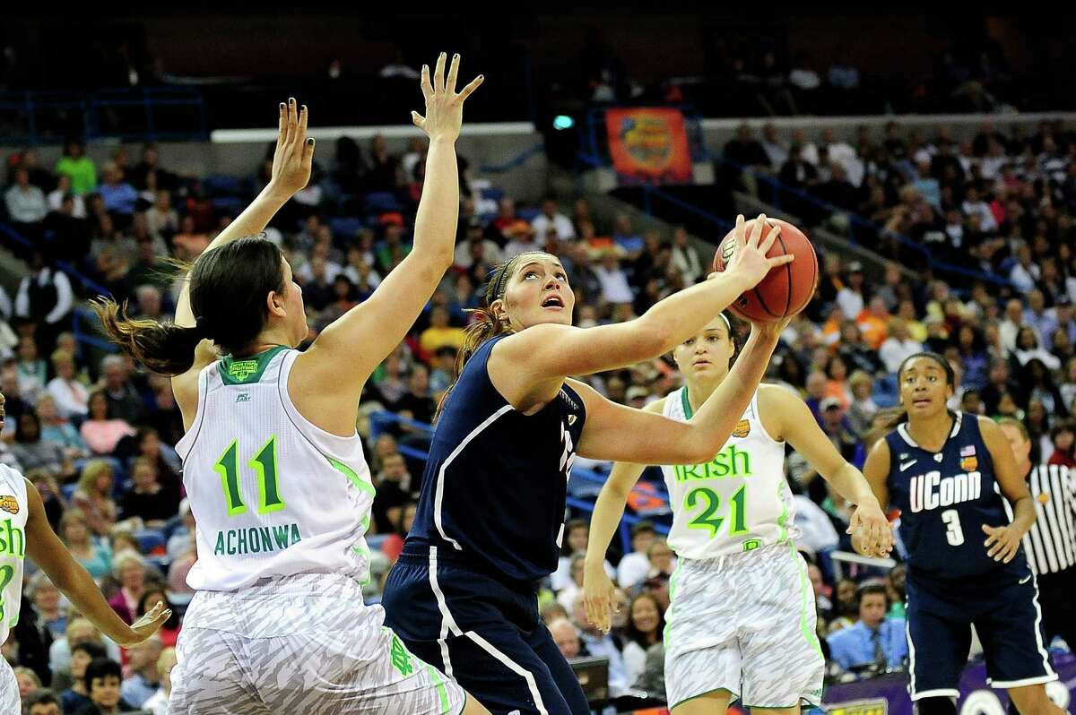 NEW ORLEANS, LA - APRIL 07: Stefanie Dolson #31 of the Connecticut Huskies looks to shoot over Natalie Achonwa #11 of the Notre Dame Fighting Irish during the National Semifinal game of the 2013 NCAA Division I Women's Basketball Championship at New Orleans Arena on April 7, 2013 in New Orleans, Louisiana.