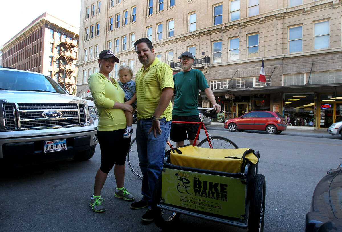 Heather Monroe and her husband, Shane Broussard (center), run the Bike Waiter, delivering orders from restaurants by bicycle.