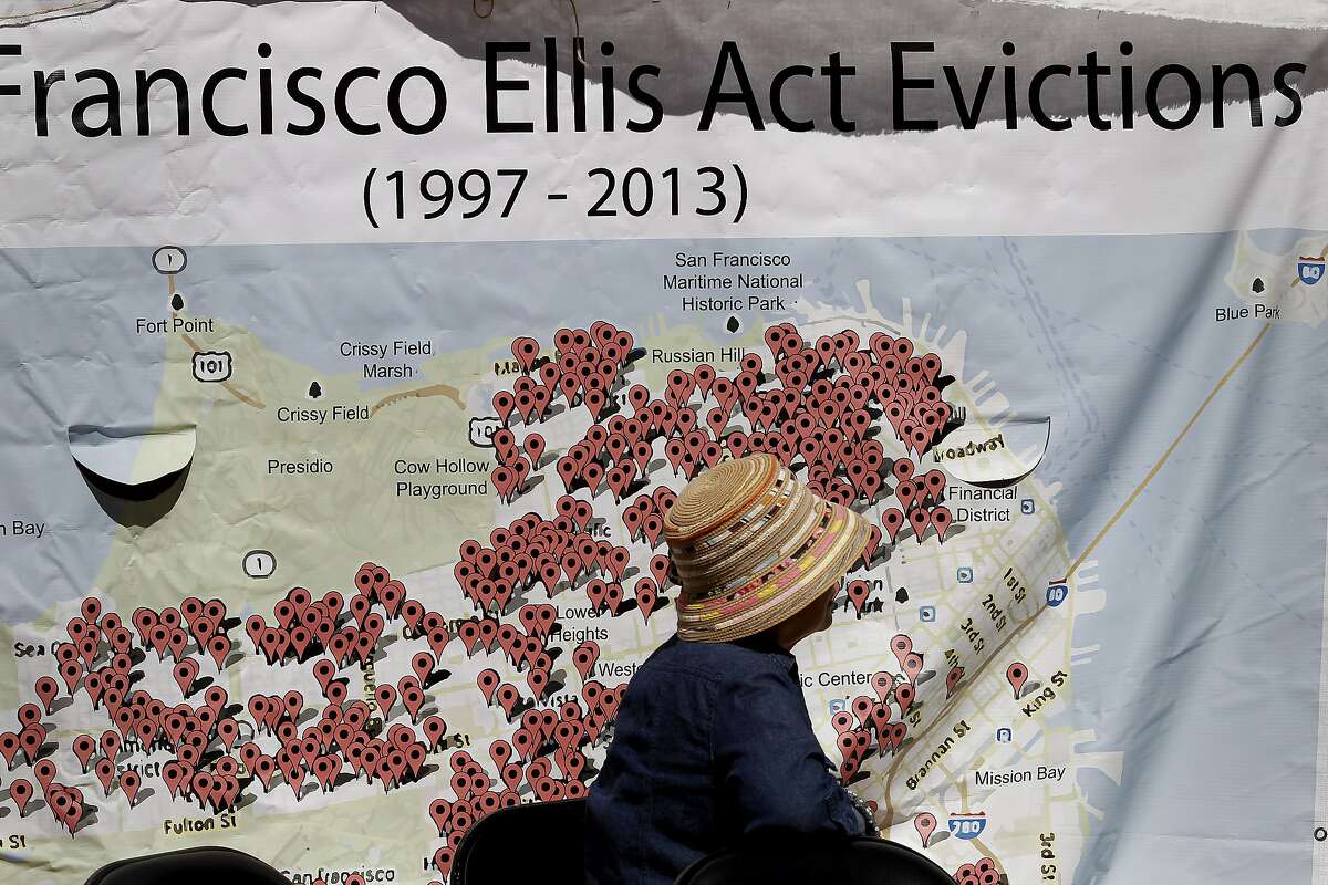 A woman sat in front of a large chart showing the numbers of evictions because of the Ellis Act since 1997 Wednesday September 25, 2013 in San Francisco.