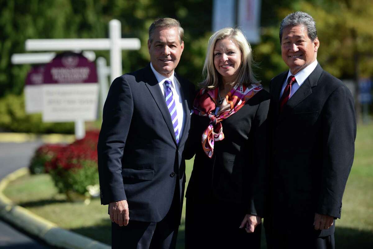 Ron Peltier, CEO and Chairman, HomeServices of America, Candace Adams, CEO, Berkshire Hathaway Home Services New England Properties and Earl Lee, CEO, HSF Affiliates LLC, pose together for a photo Wednesday, Sept. 25, 2013 in Wallingford, Conn.