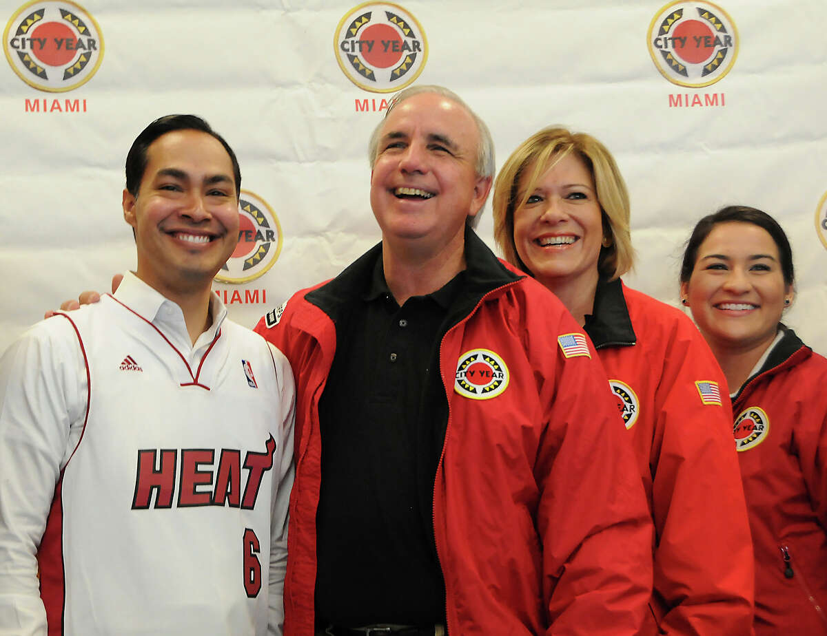 Miami-Dade Mayor Carlos A.Gimenez, second from left, persented San Antonio Mayor Julian Castro, left, with a Heat jersey, Wednesday, September 25, 2013, just before their work day with City Year began at Kelsey L.Pharr Elementary School, 2000 NW 46th St. On the right are Tere Blanca and Caroline Arroyo both with City Year. The mayors joined over 50 volunteers, from City Year, for a beautification day at the school.