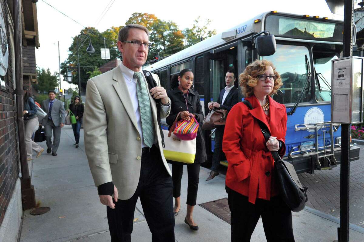 Commuters arrive by bus to the train station in Brewster, N.Y. to take the 7:14 a.m. train to Grand central Station in New York City, Thursday, Sept. 26, 2013. A power failure on the rail line in the Stamford, Conn. area early Wednesday morning has disrupted the commute for many in the area.