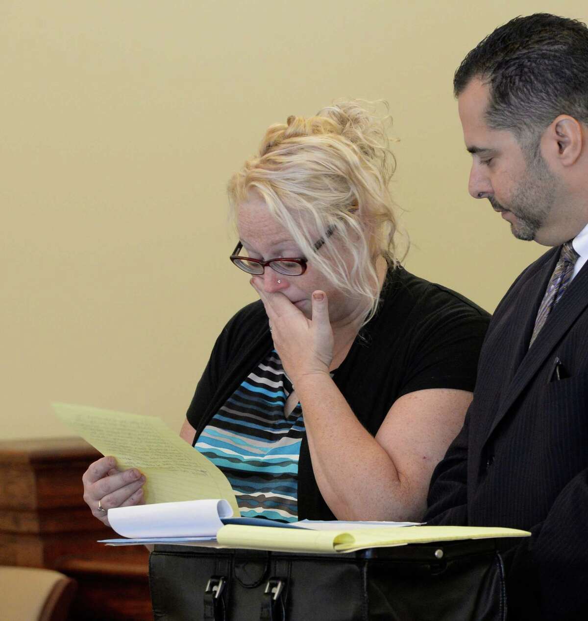 Becky Goodermote, 38, of Hoosick, is overcome by emotion as she took a plea bargain Thursday afternoon, Sept 16, 2013, in Rensselaer County Court in Troy, N.Y. Goodermote was charged with manslaughter, driving while impaired by drugs and leaving the scene of a Labor Day 2012 crash that killed a bicyclist. Standing with her is her attorney Michael Jurena. Goodermote's car, hit Matthew Ratelle, 40, of Petersburgh. (Skip Dickstein / Times Union)