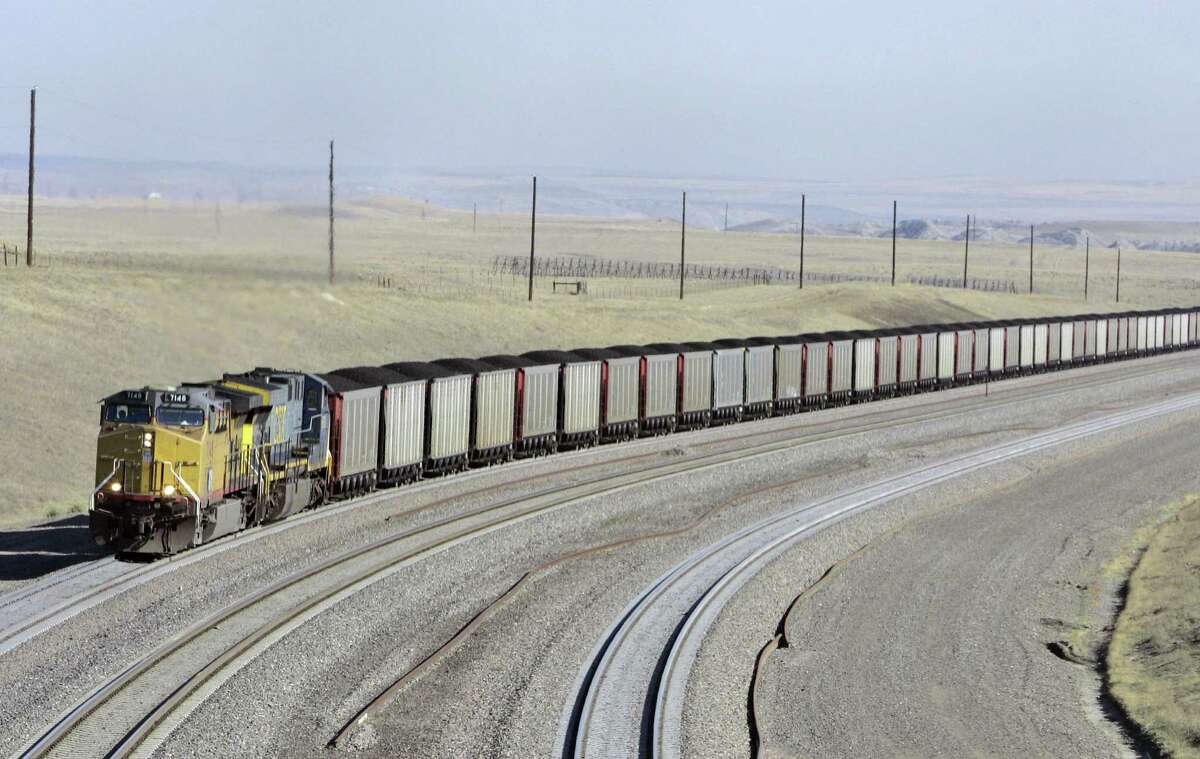 A coal train travels in northeast Wyoming. Tough new limits on the amount of carbon dioxide emissions that new power plants can emit, proposed by the Obama administration, will likely accelerate a shift away from coal-fired power.