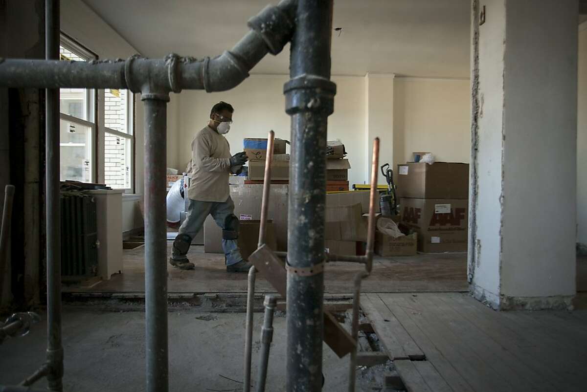 A worker renovates an apartment in the Park Lane, a Nob Hill apartment building on September 19th 2013. Apartments in the building will soon go on sale making the building one of the most expensive TICs in the city.