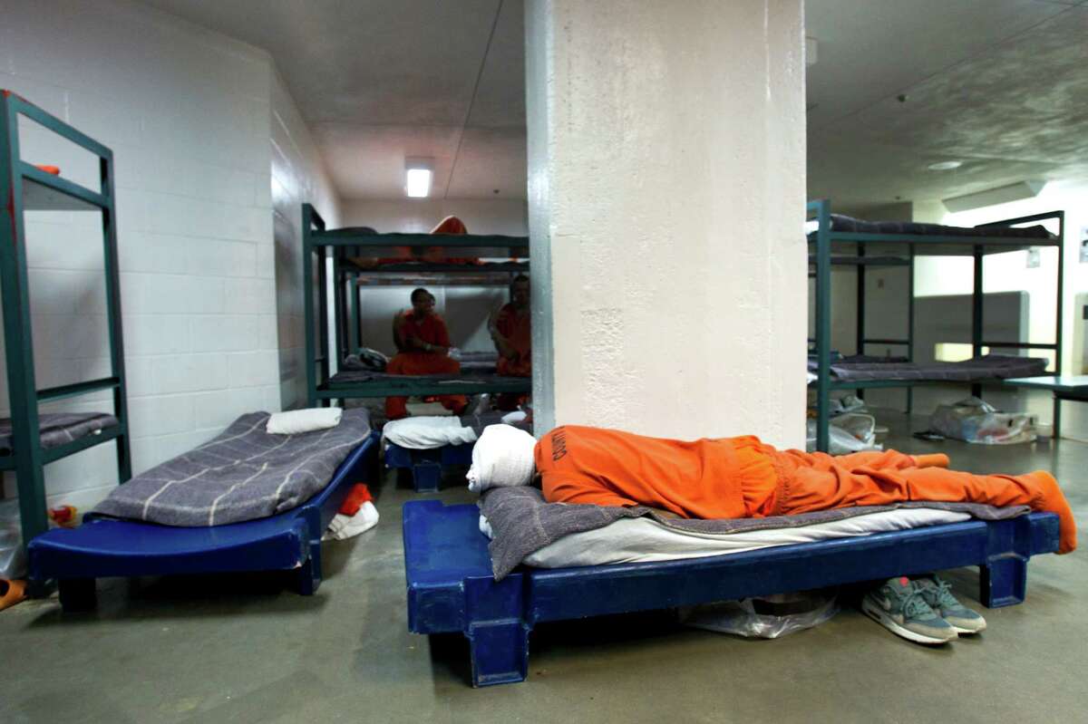 An inmate sleeps ﻿at the Harris County Jail on Thursday. The population is near capacity and most of the ﻿variance beds are being used for inmates to sleep on.