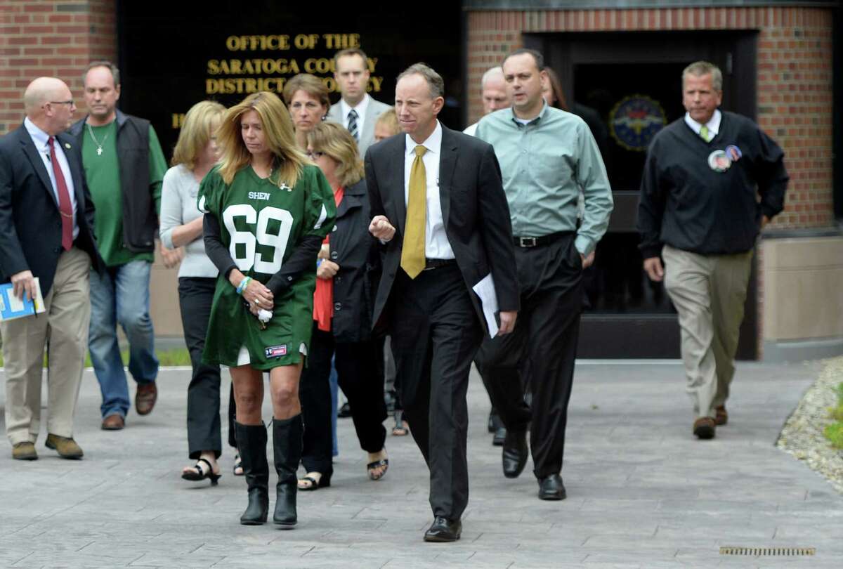 Saratoga County District Attorney James Murphy III, center, surrounded by family members of those killed or injured in the crash in which Dennis Drue pleaded guilty on Friday Sept. 27, 2013, in Saratoga County Court in Ballston Spa, N.Y. (Skip Dickstein/Times Union)