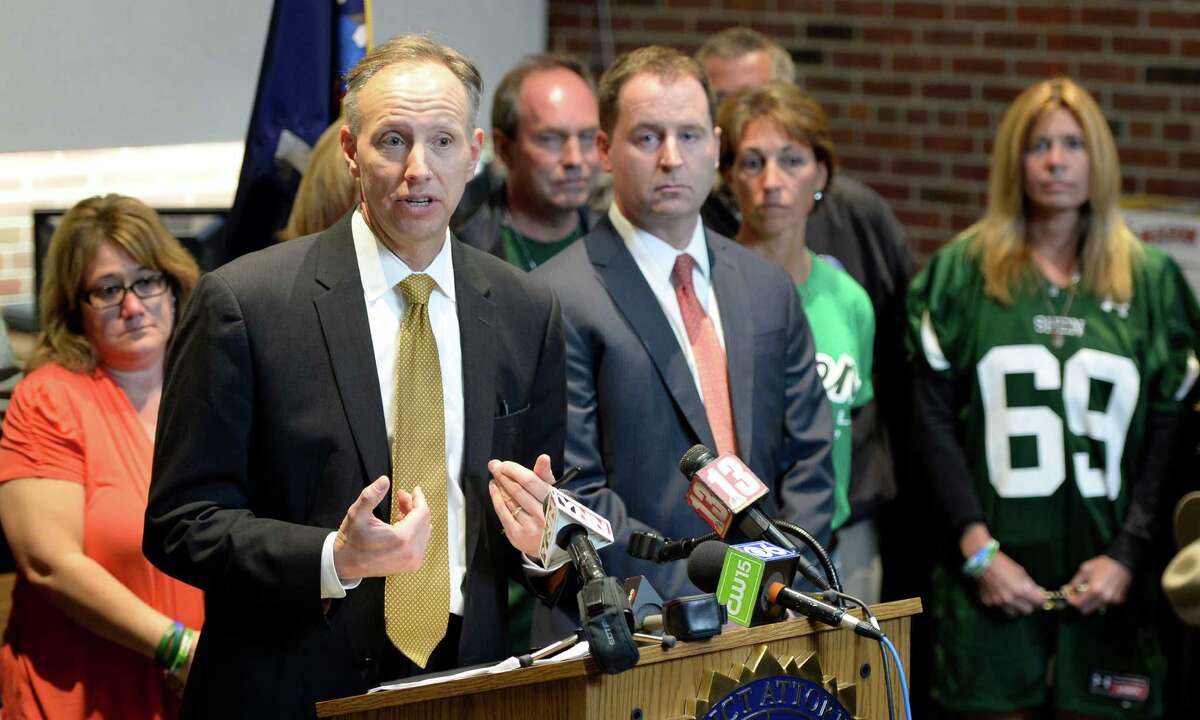 Saratoga County District Attorney James Murphy III, center, surrounded by family members of those affected by the accident in which Dennis Drue pleaded guilty Friday Sept. 27, 2013 in Saratoga County Court in Ballston Spa, N.Y. (Skip Dickstein/Times Union)