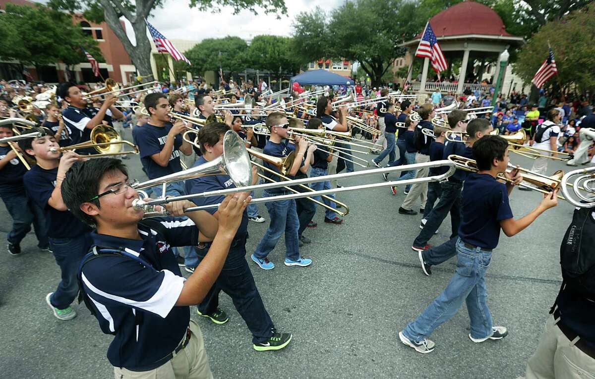 Members of the Smithson Valley High School Marching Band play as they pass the center of New Braunfels during the Comal County Fair Parade, on Friday, Sept. 27, 2013.