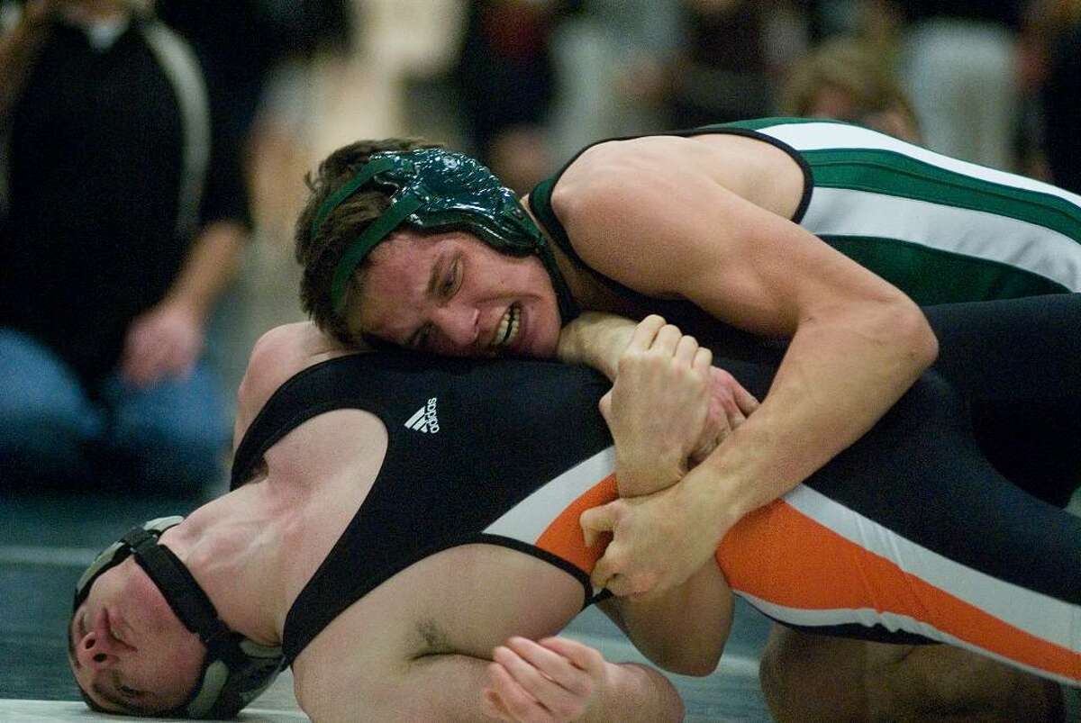 From Left, Brian Antunes of Shelton and Karl Bradshaw of New Milford compete during the New Milford Invitational wrestling tournament Saturday at New Milford High School.