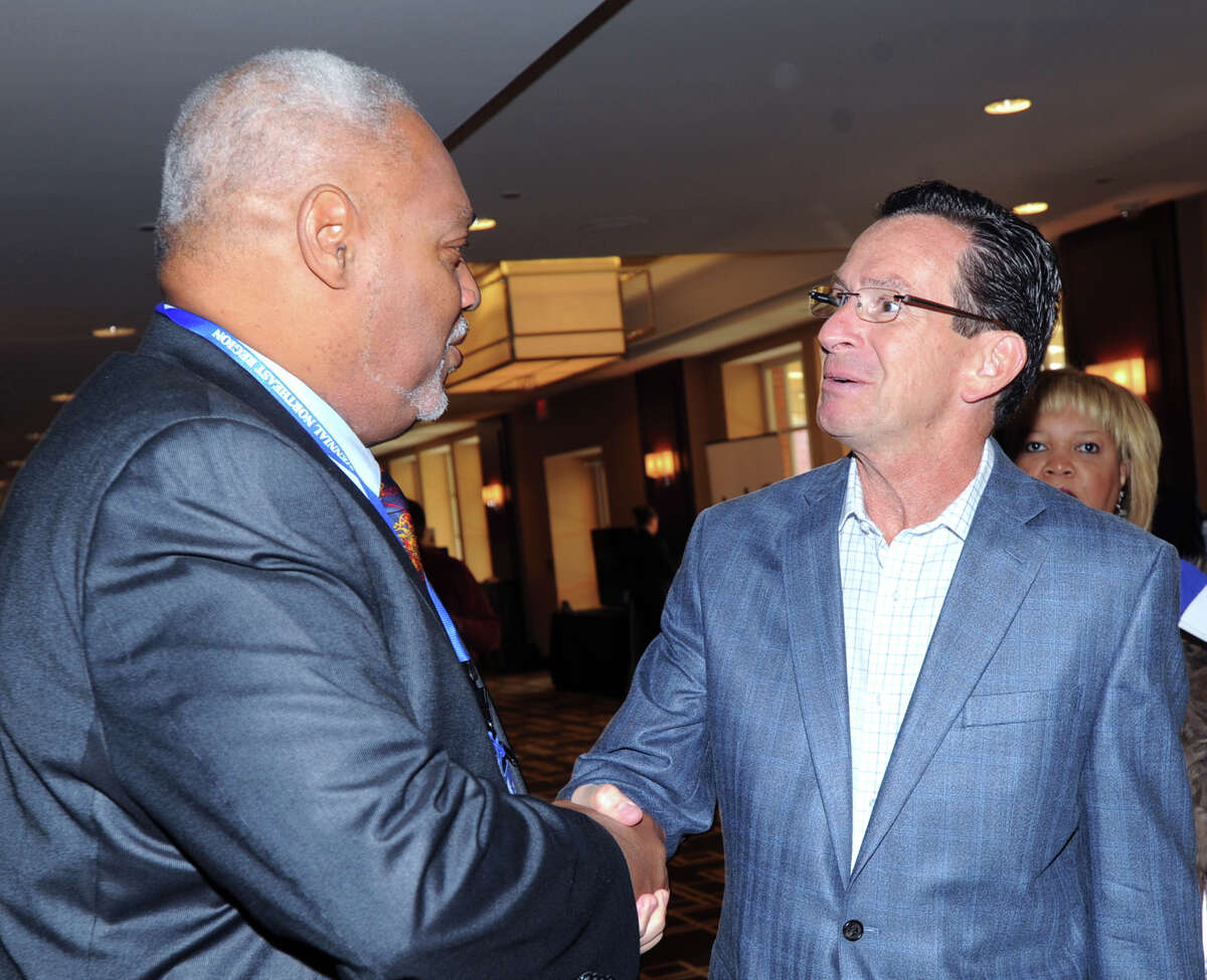 At left, Cornell Wright, sire archon of the Fairfield Chapter of Delta Nu of the Sigma Pi Phi Fraternity, shakes hands with Gov. Dannel P. Malloy prior to a speech Malloy made as part of the Delta Nu Boule hosting of the Sigma Pi Phi FraternityâÄôs 20th meeting of the Northeast Regional Boule at Hyatt Regency Greenwich, Saturday morning, Sept. 28, 2013.