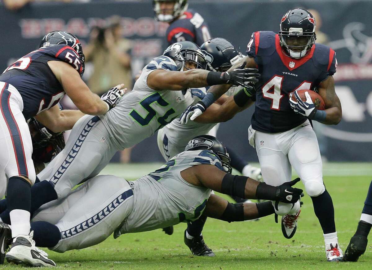 Houston Texans' Ben Tate (44) runs past Seattle Seahawks' Bobby Wagner (54) during the first quarter an NFL football game Sunday, Sept. 29, 2013, in Houston. (AP Photo/David J. Phillip)
