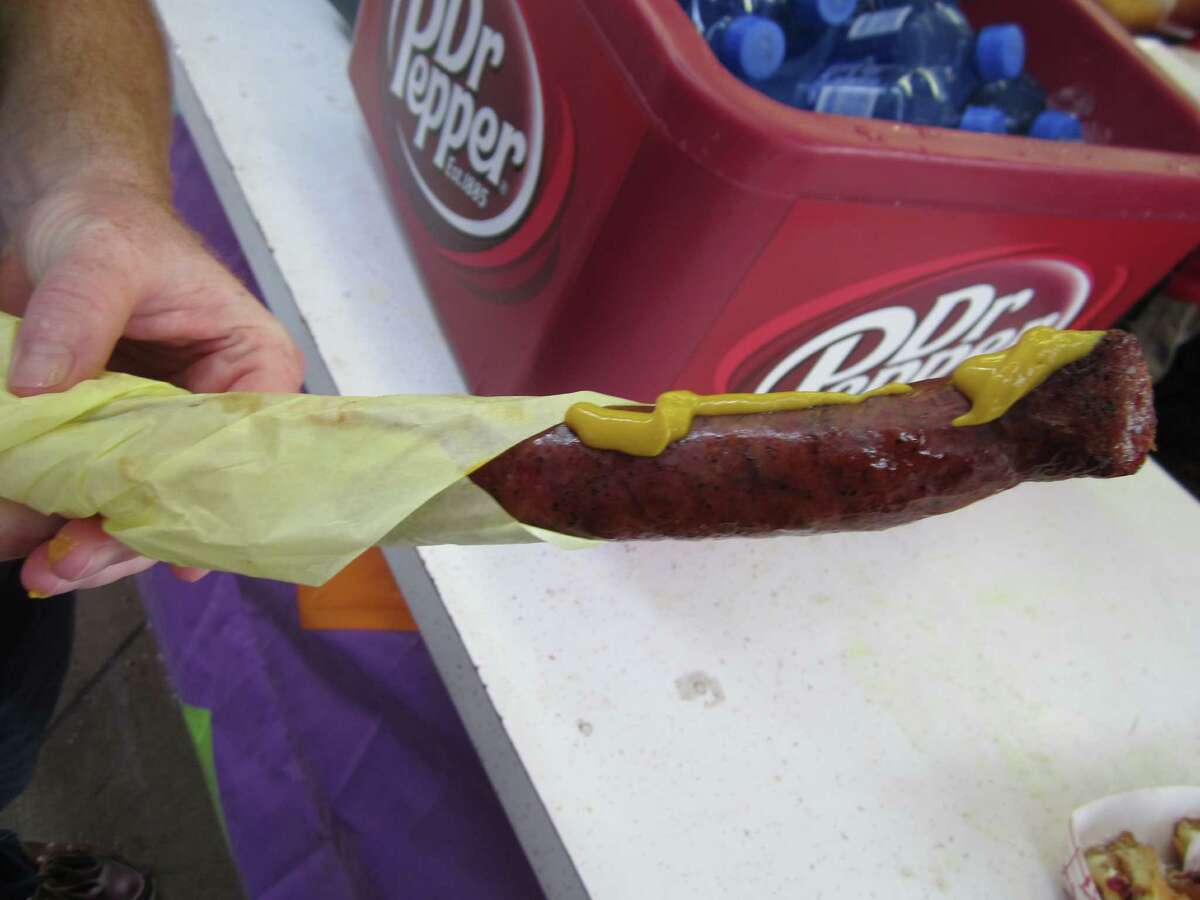 Food vendor Hans Meueller serves its famous sausage at its Tent of Bavarian Delights at the State Fair of Texas.