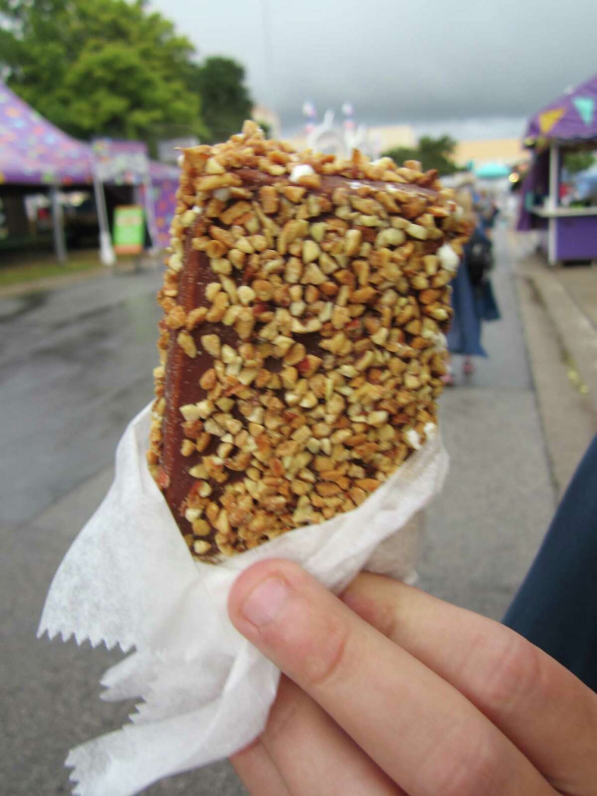 State Fair of Texas attendees beat the heat with a peanut-covered, chocolate-dipped ice cream bar.